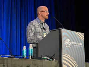 Developer and professor Christopher Totten at the GDC podium