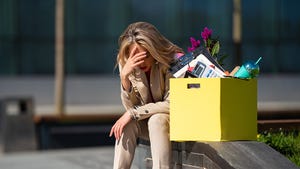 Person sitting with head in their hands